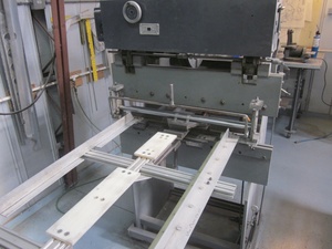 An arbor press set up to make the a small bend
                    required in the fabrication of a Cessna lower
                    aileron skin