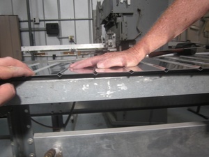 An arbor press set up to make the a small bend
                    required in the fabrication of a Cessna lower
                    aileron skin